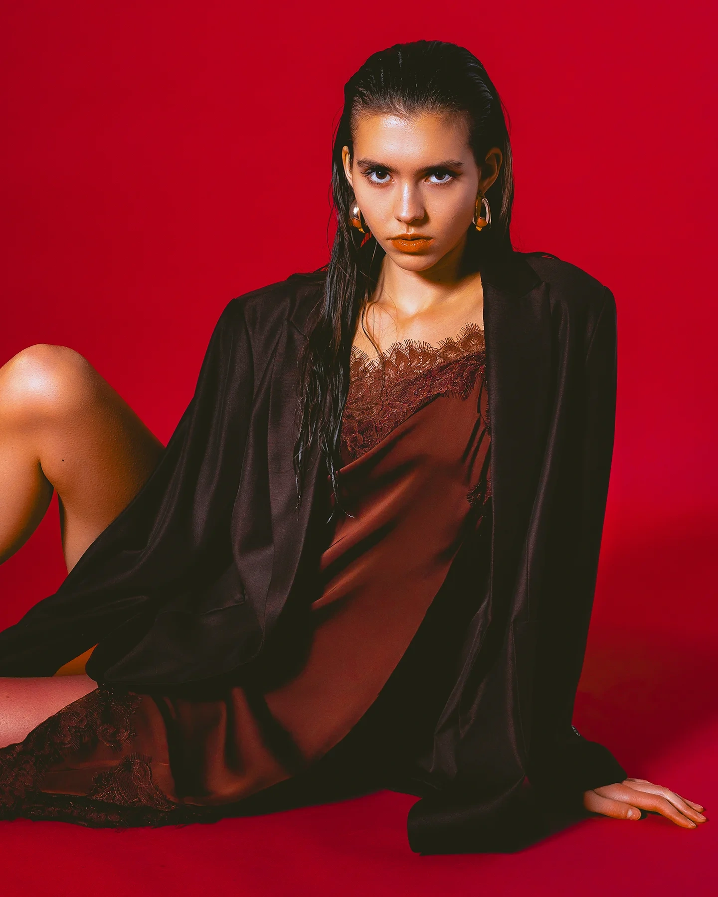 Stella editorial portrait with crimson backdrop and color-matched clothing