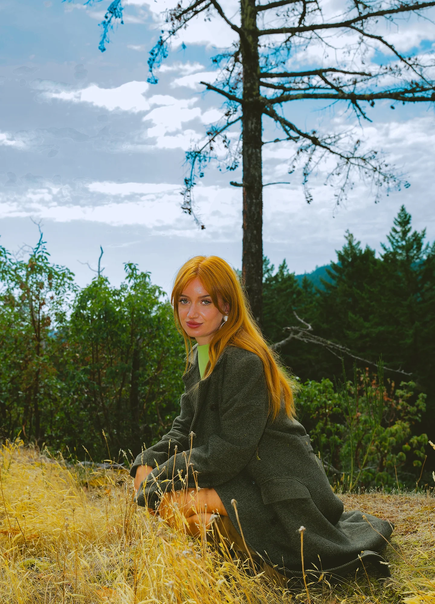 Natural light fashion portrait of March with tree-lined backdrop