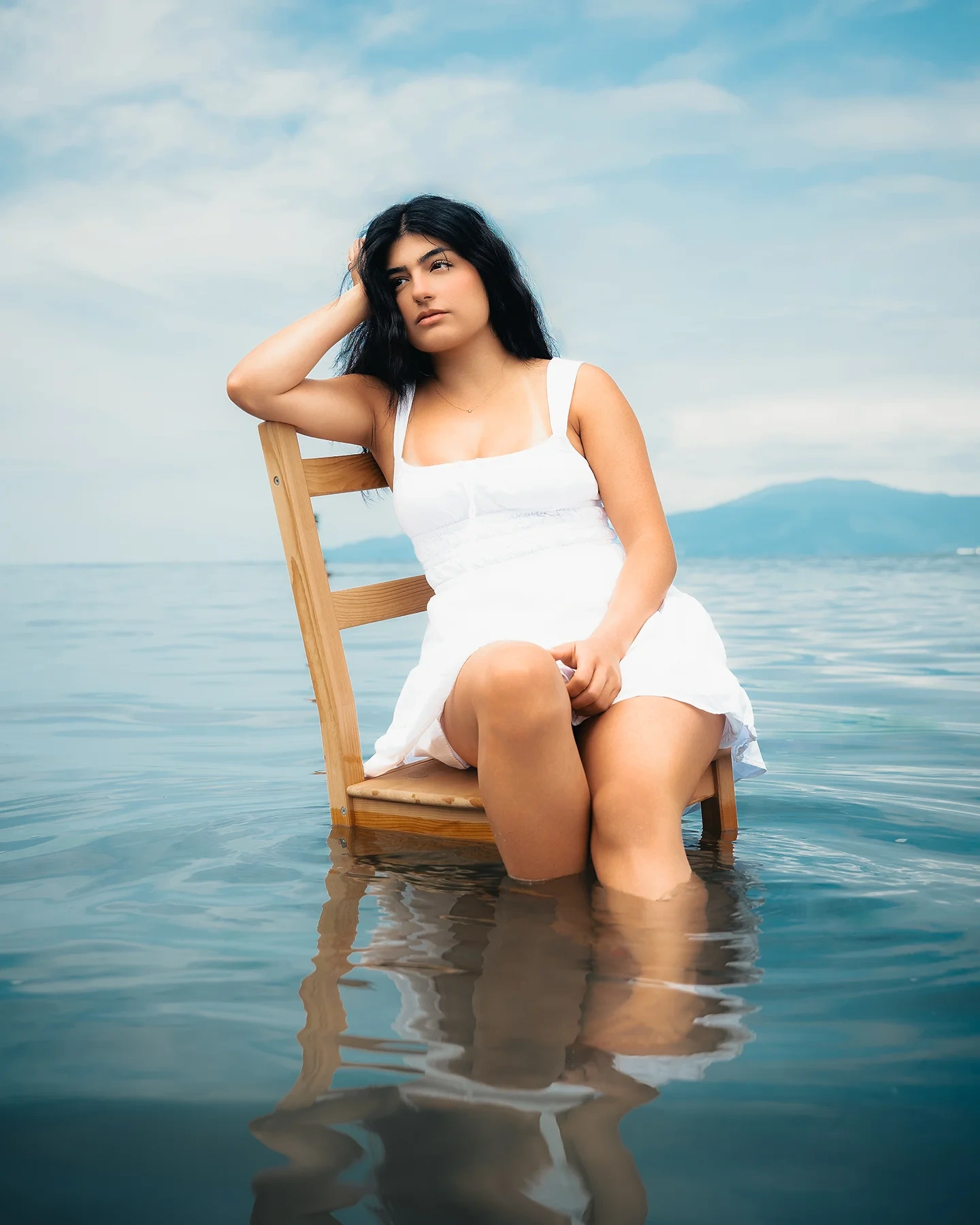 Closing ocean portrait of Tina in a white dress from the editorial series